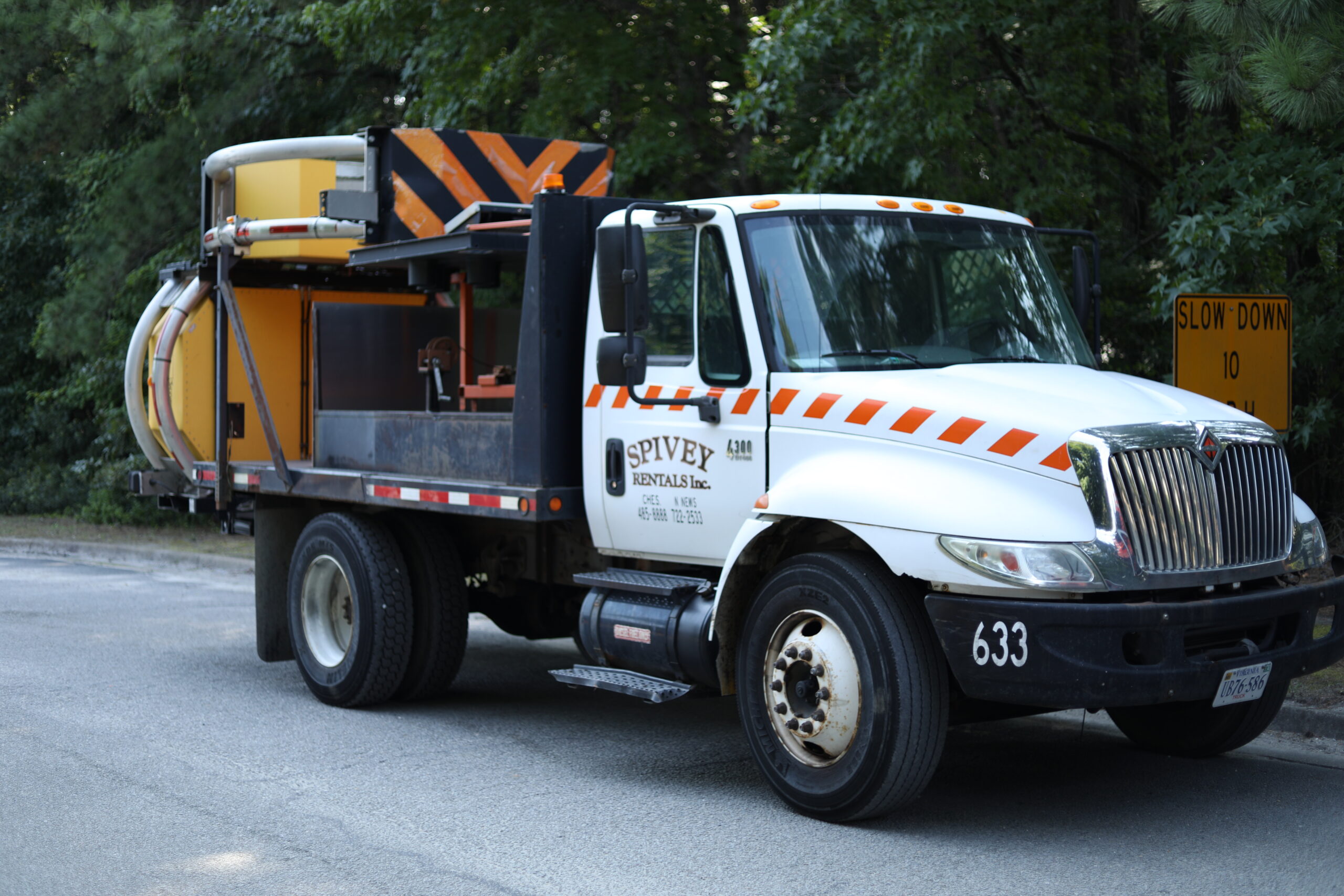 A Spivey Services-branded truck mounted attenuator parked on the side of the road