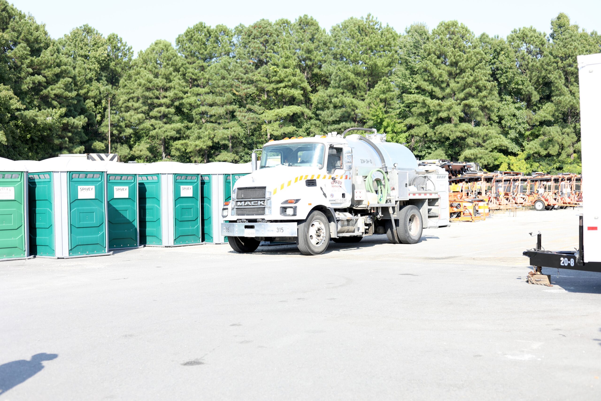 Portable toilet rental Chesapeake VA setup featuring rows of porta potties and a Spivey Services pump truck