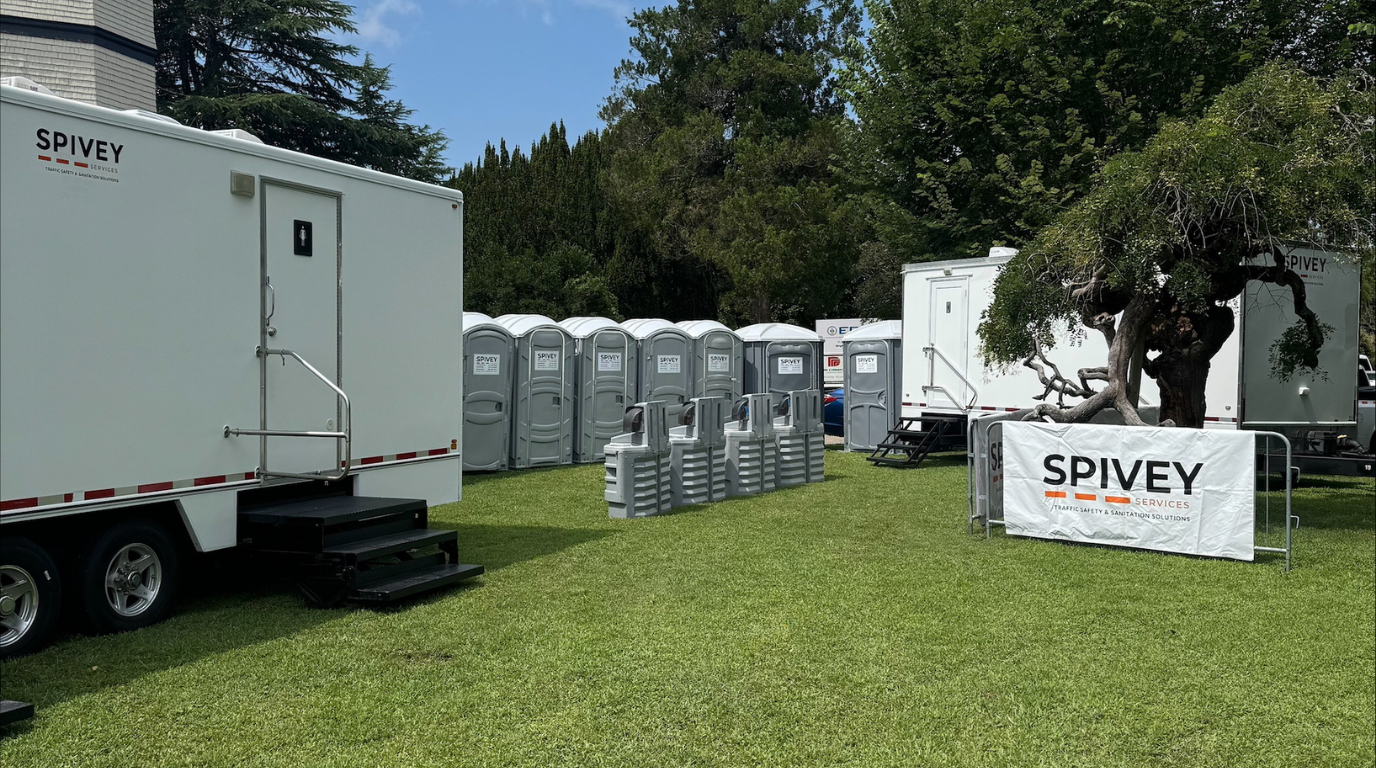 A Spivey Services portable sanitation setup for a summer festival with portable toilets, hand wash stations, and restroom trailer